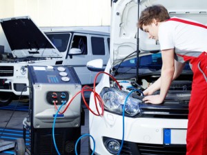 Car mechanic checking the air handling unit of a car